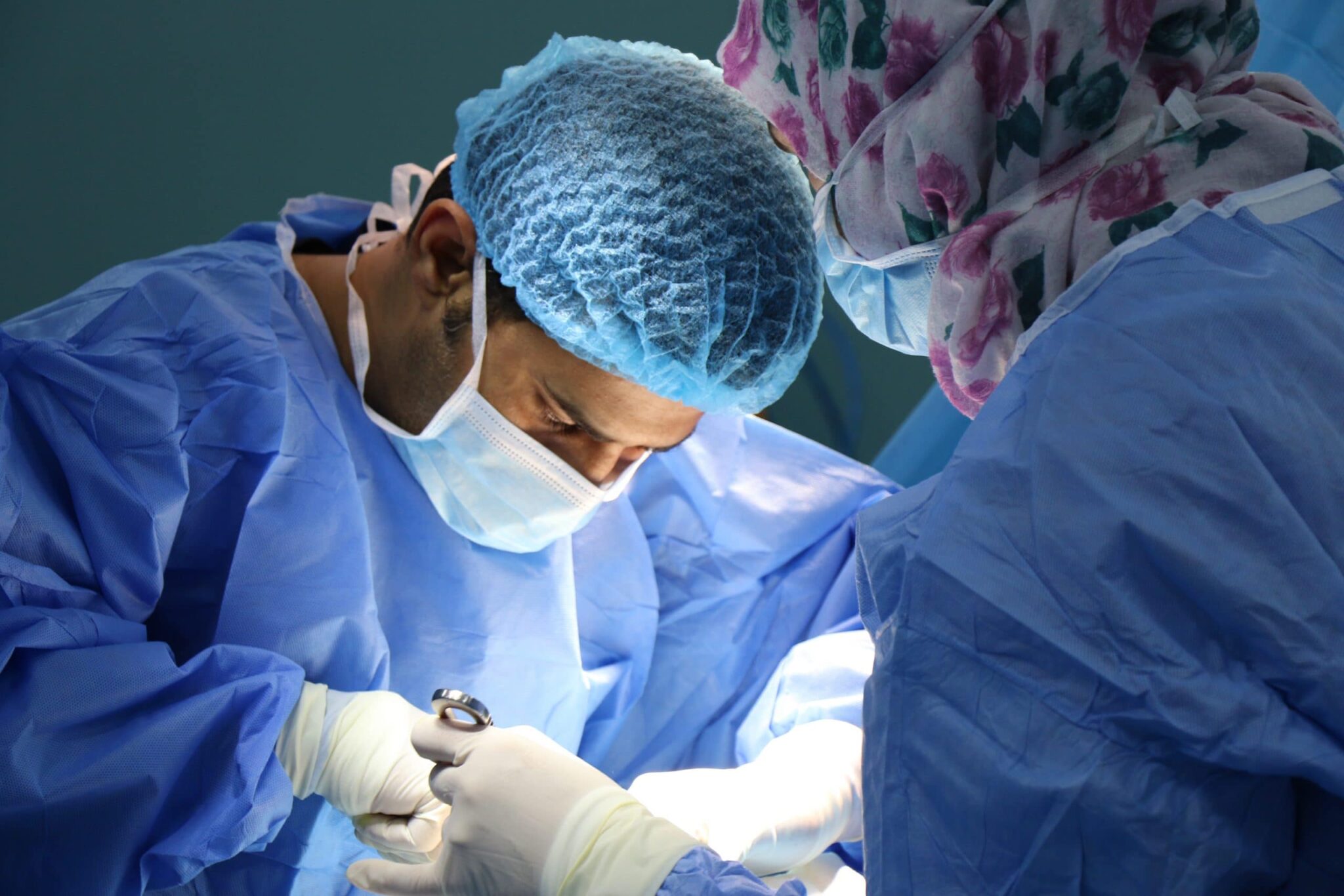 Doctor and medical assistant performing surgery.