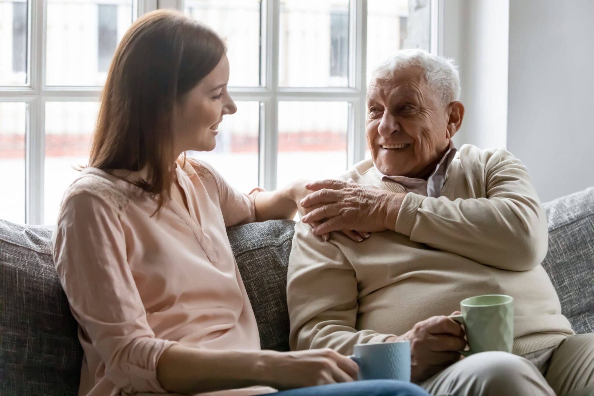 Adult daughter talking with her father.