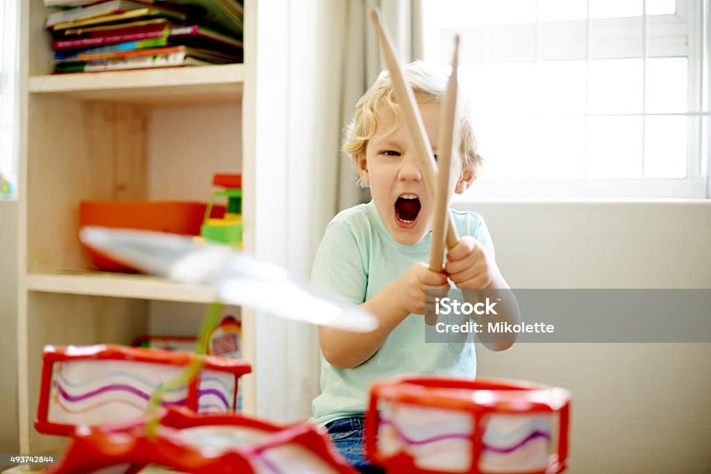 Child plays with loud drum toy